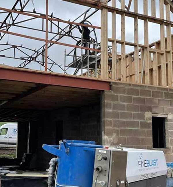 Rust removal from metal frame at construction project near Reading, Berkshire