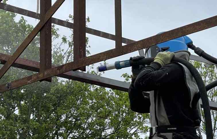 Rust removal from metal frame at construction project near Reading, Berkshire