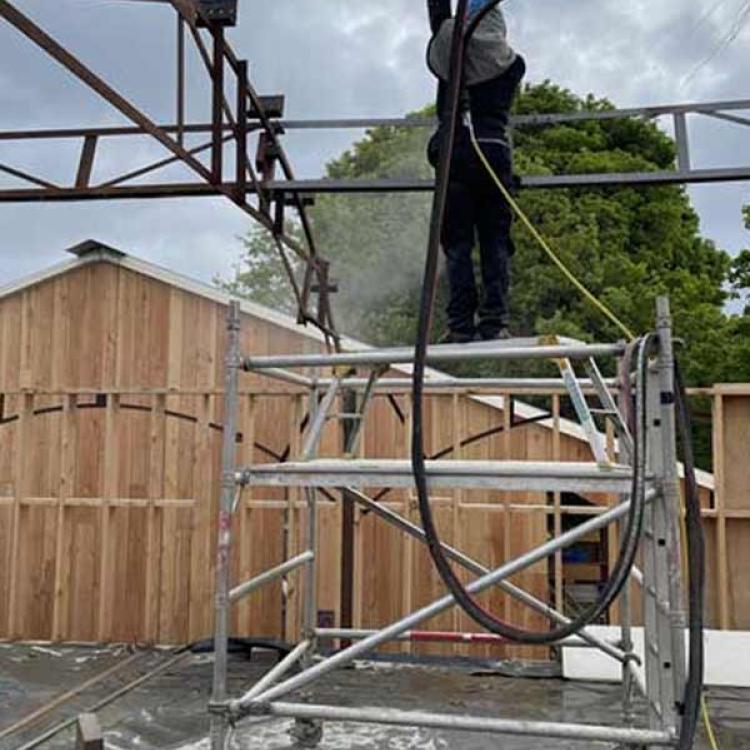 Rust removal from metal frame at construction project near Reading, Berkshire